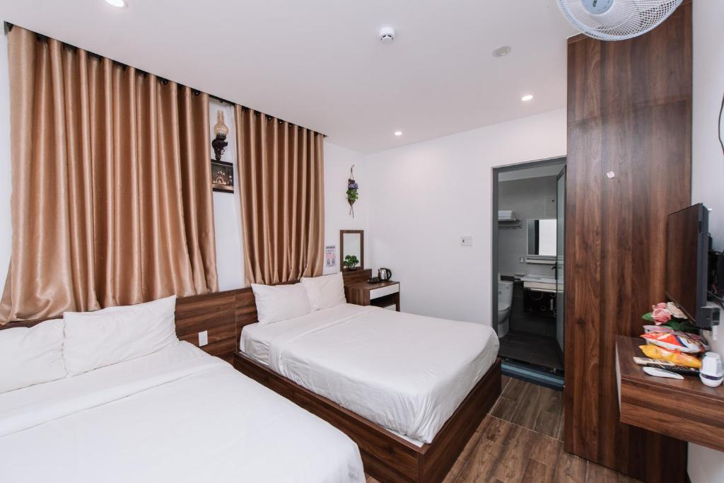 Postel nebo postele na pokoji v ubytování Nguyên Hương Hotel