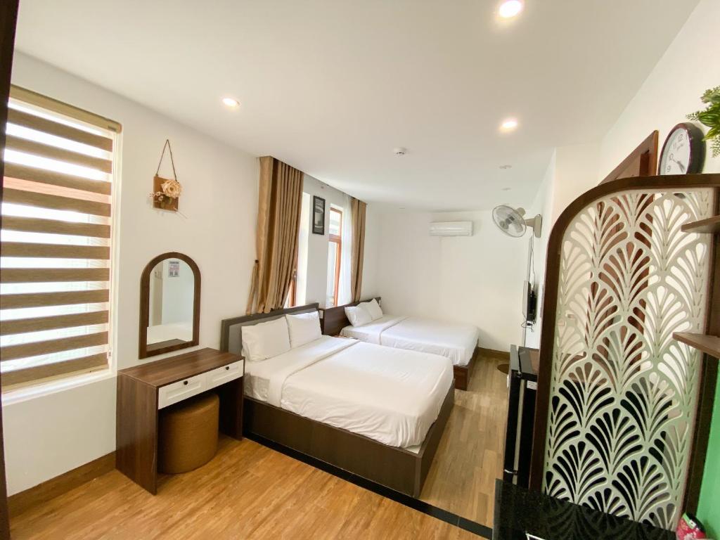 Postel nebo postele na pokoji v ubytování Nguyên Hương Hotel