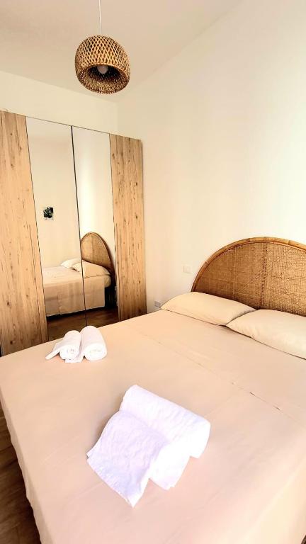 a bedroom with a bed with two towels on it at MARÈ Terracina Apartments in Terracina