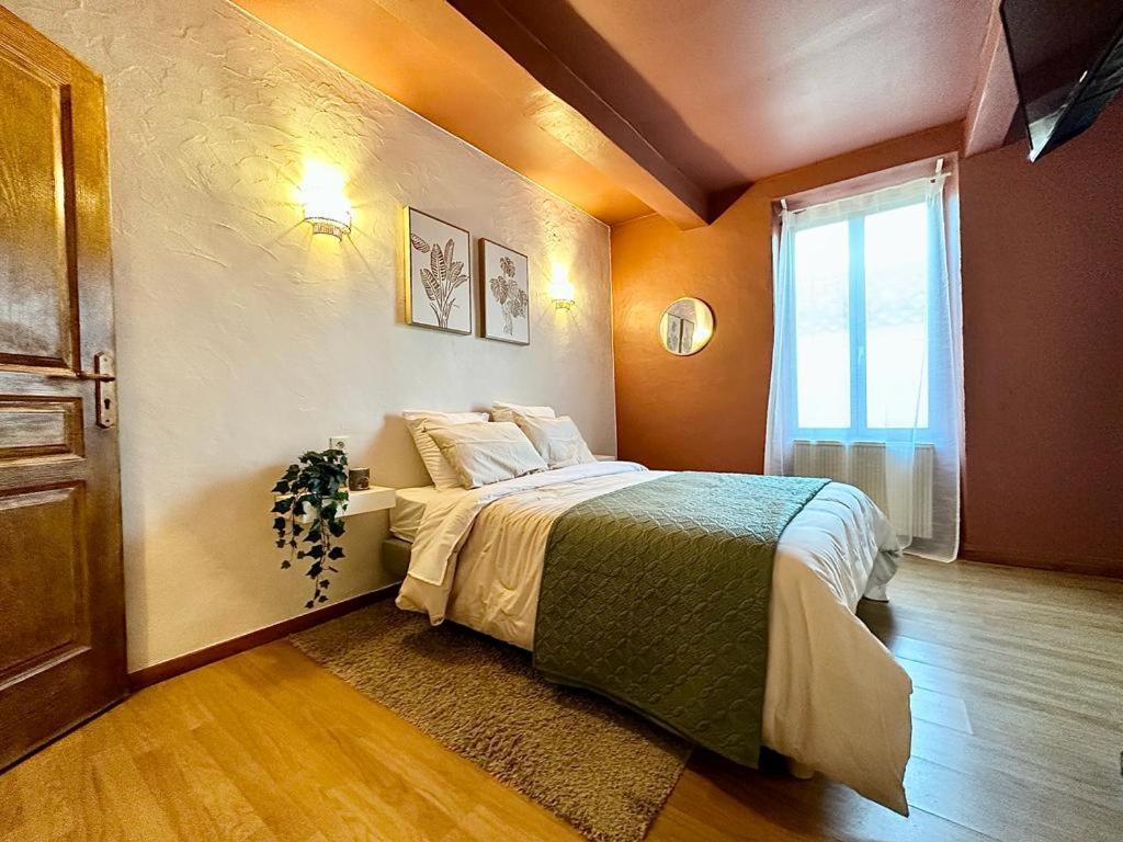 een slaapkamer met een bed en een raam bij Superbe Maison de Village in Saint-Chinian