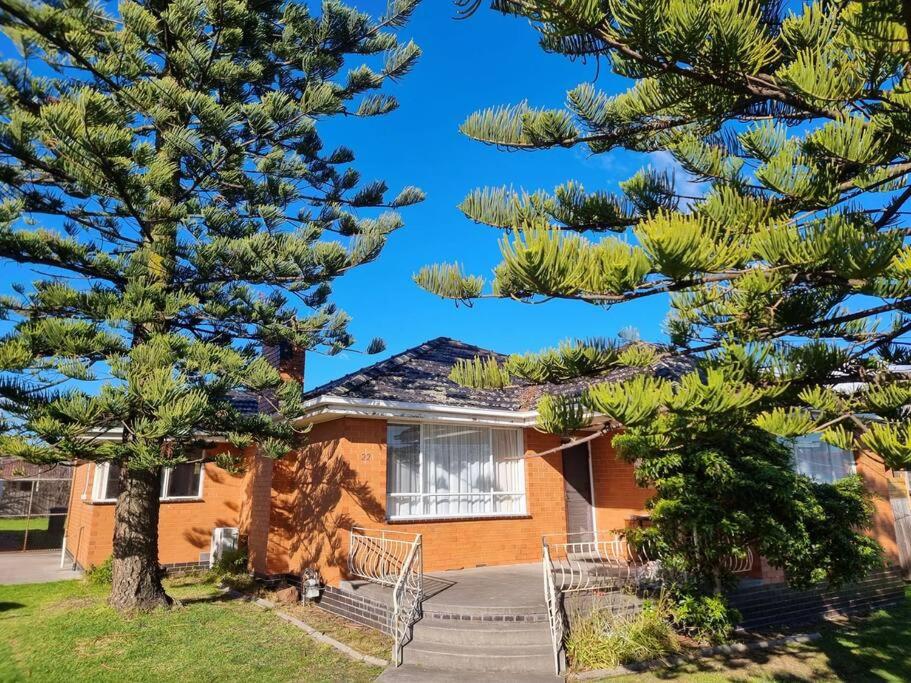 a house with two pine trees in front of it at Two Pines, whole home in Tullamarine near airport! in Melbourne