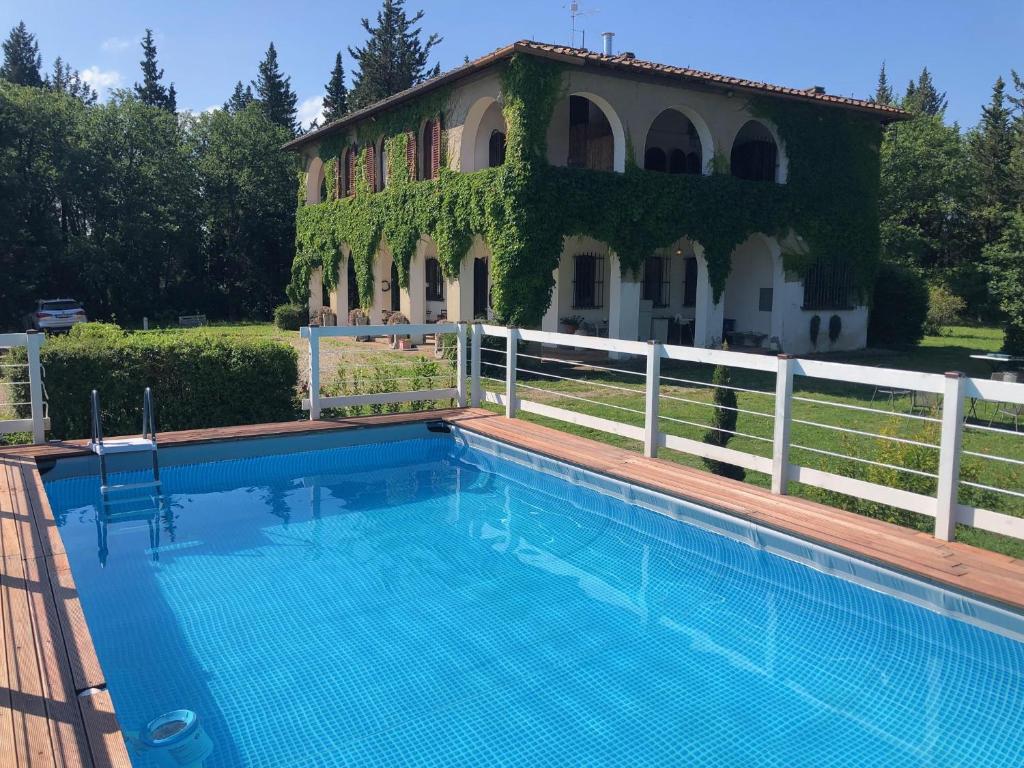 a swimming pool in front of a house at Villa Albertina in Montespertoli