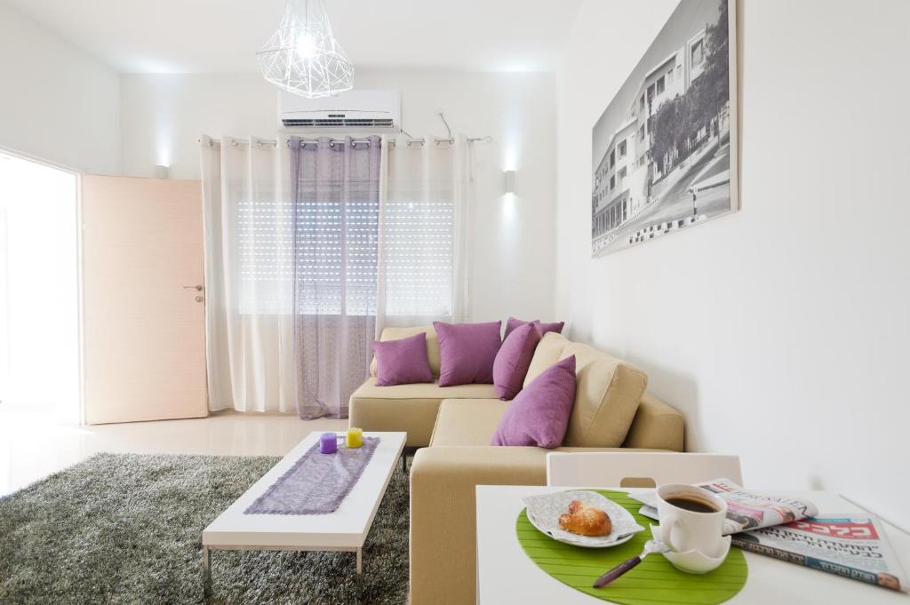 a living room with a couch and a table at Eshkol Housing Haifa -Executive Apartments in Haifa