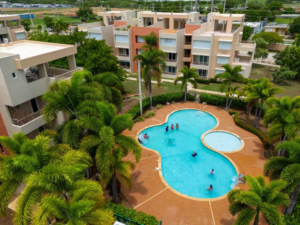 an overhead view of a swimming pool at a resort at Coqui Beach Home, Paseo del Faro Combate in Cabo Rojo