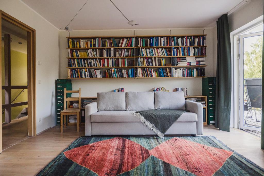 a living room with a couch and bookshelves at Susimetsa 