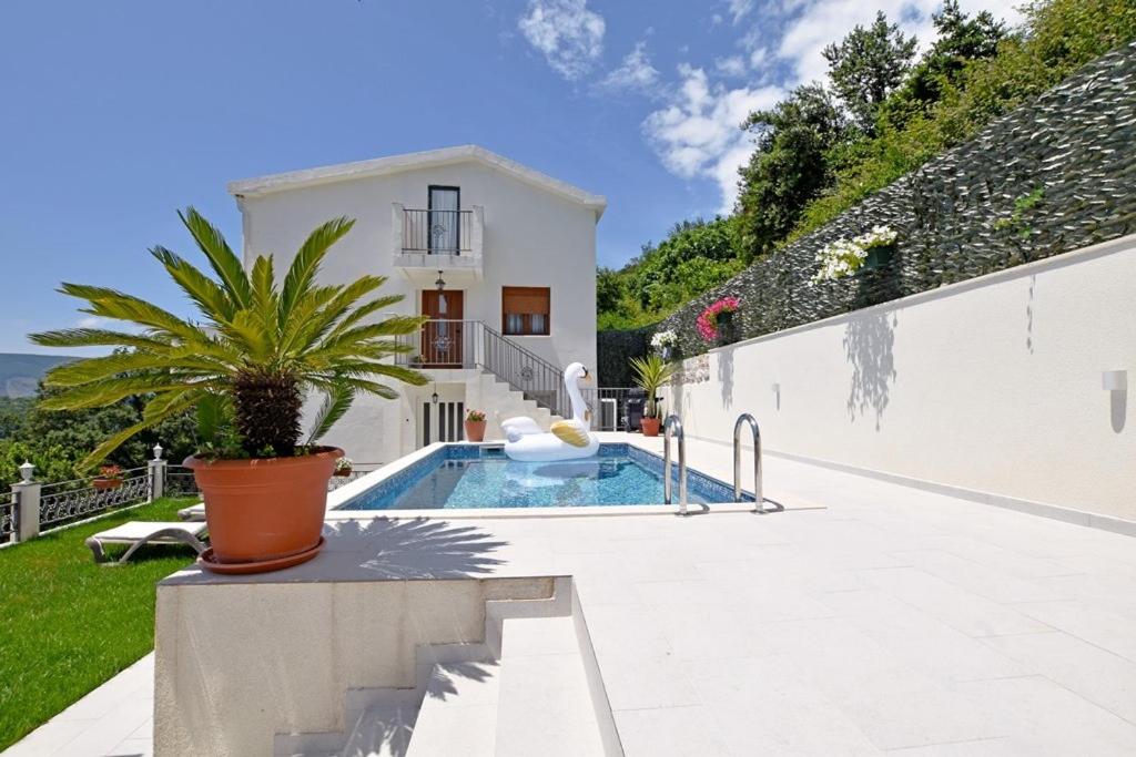 a villa with a swimming pool and a house at Vila Djordjevic in Herceg-Novi