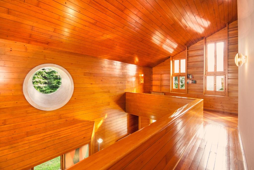 d'un sauna aux murs en bois et d'une fenêtre circulaire. dans l'établissement Villa di design con grande parco, à Trévise