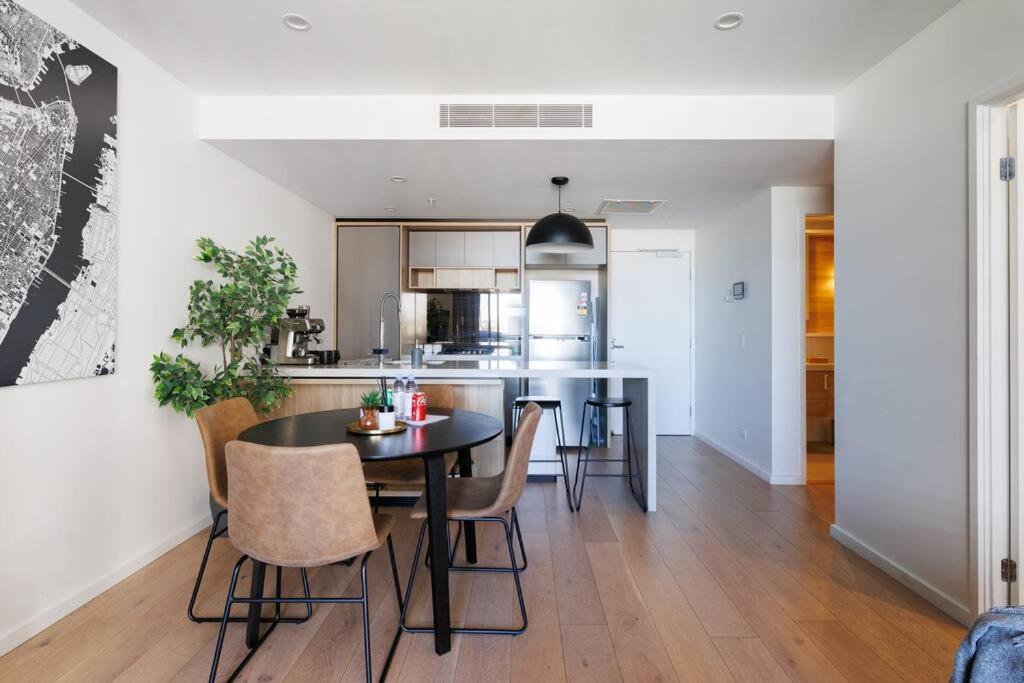 a kitchen and dining room with a table and chairs at Luxurious 2 Bed City Scape Retreat with Rooftop in Brisbane