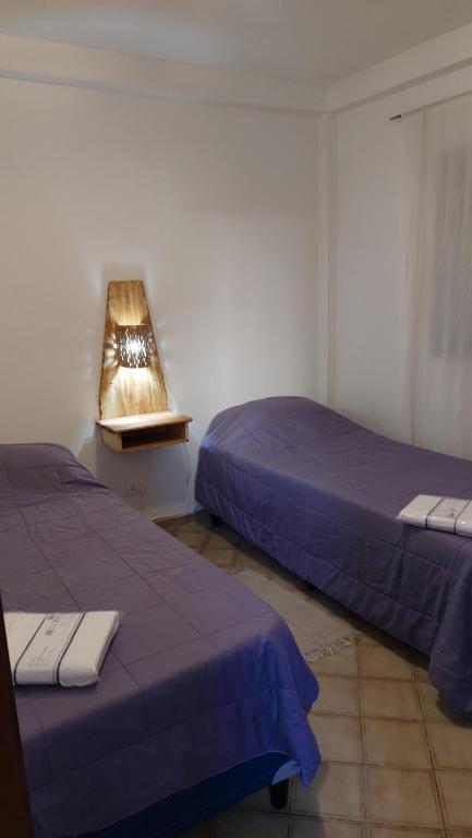 a bedroom with two beds and a lamp in it at Apartment Chunin Depart in Salta