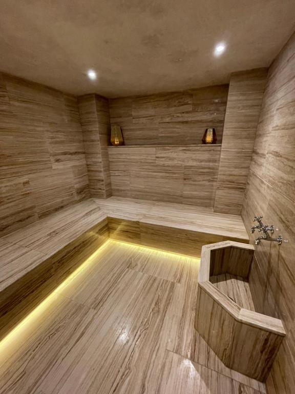 a sauna with a wooden floor and a tub at Villa La Falaise in Oualidia