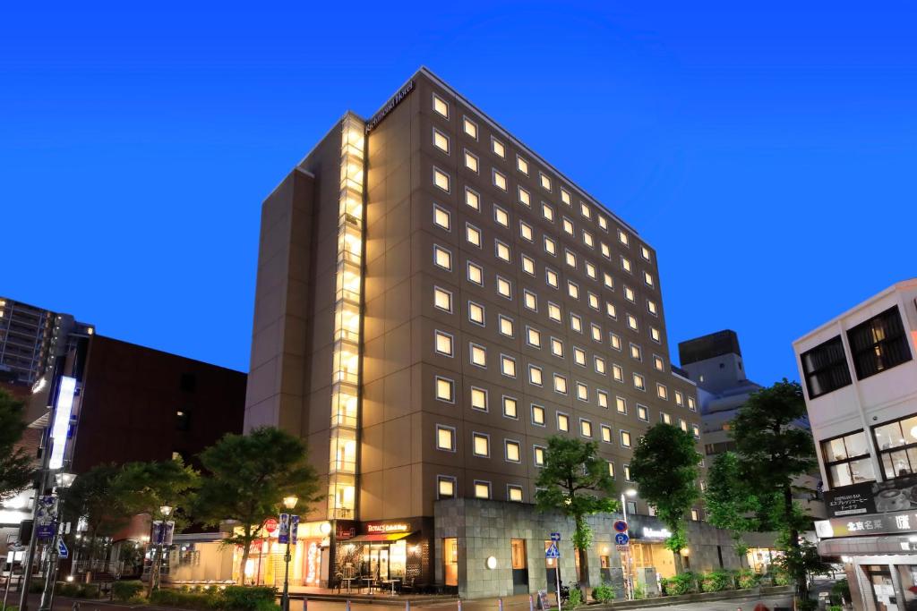 a tall building in a city at night at Richmond Hotel Yokohama-Bashamichi in Yokohama