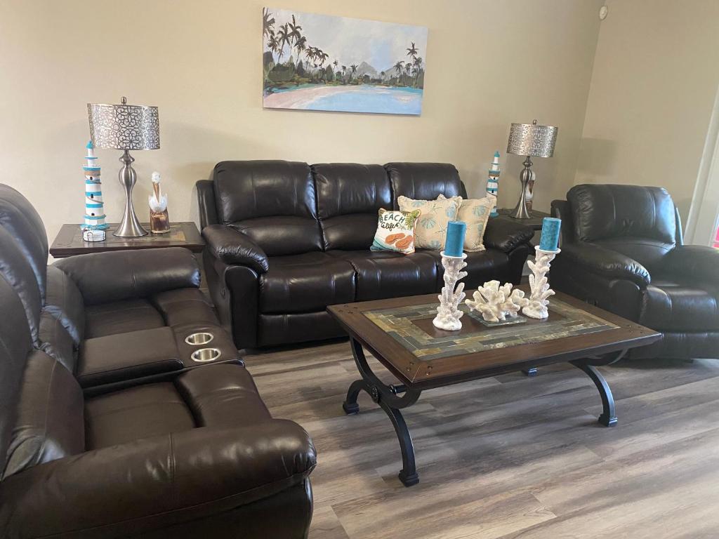 a living room with a leather couch and a coffee table at Vera’s vacation in Bradenton