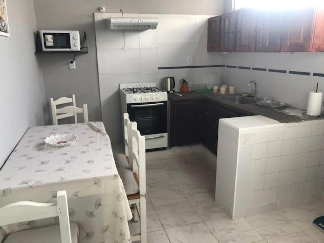 a kitchen with a table and a stove top oven at comoencasa2 in Mercedes