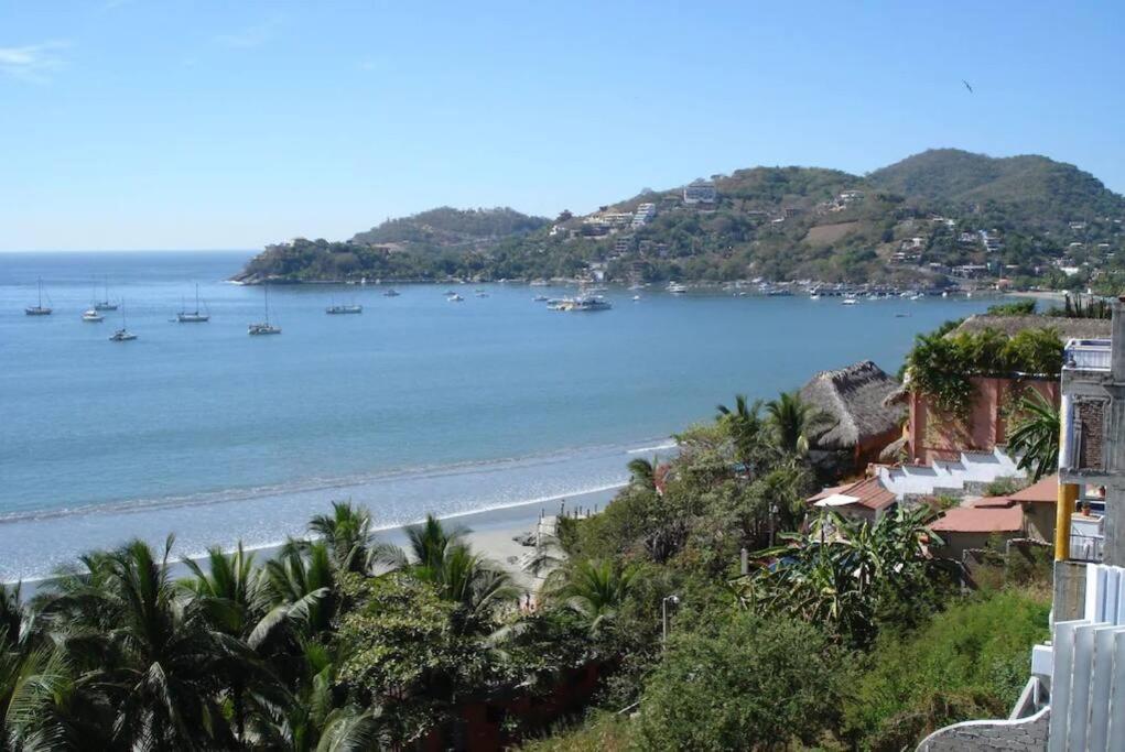 a view of a beach with boats in the water at Vista Bahia Zihua in Zihuatanejo