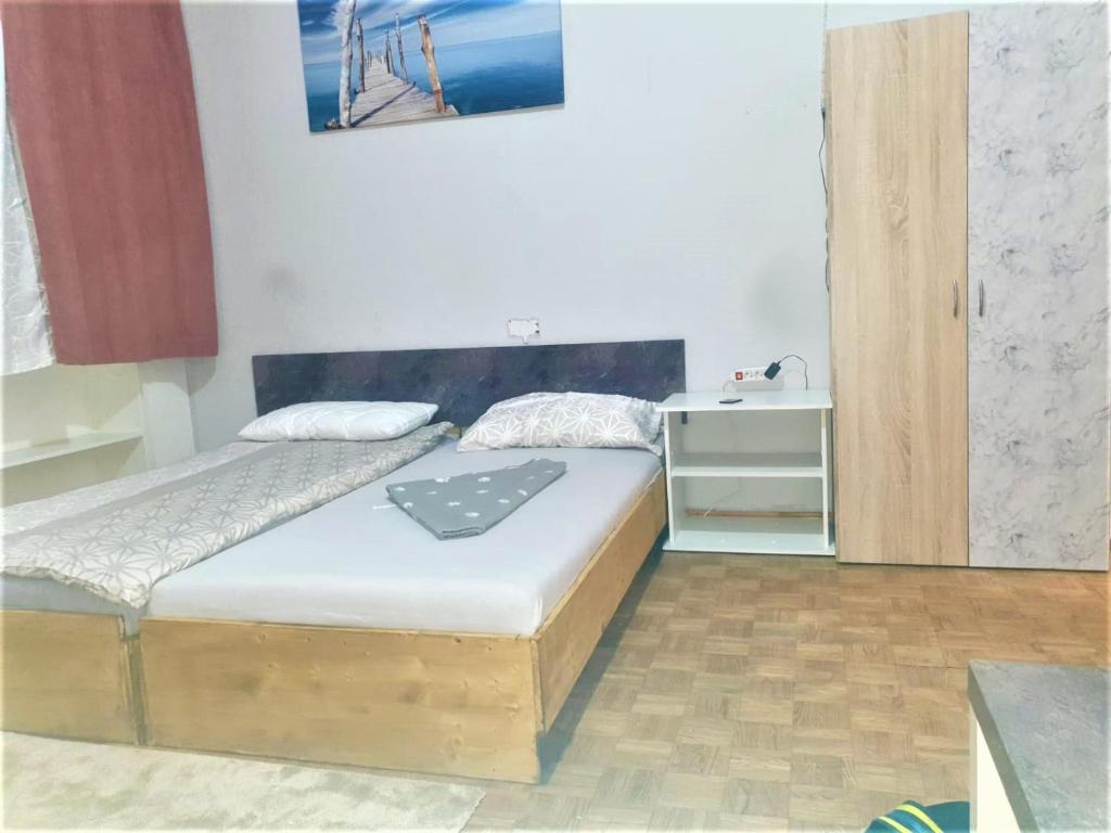 a small bedroom with two beds and a desk at near the center in Vienna