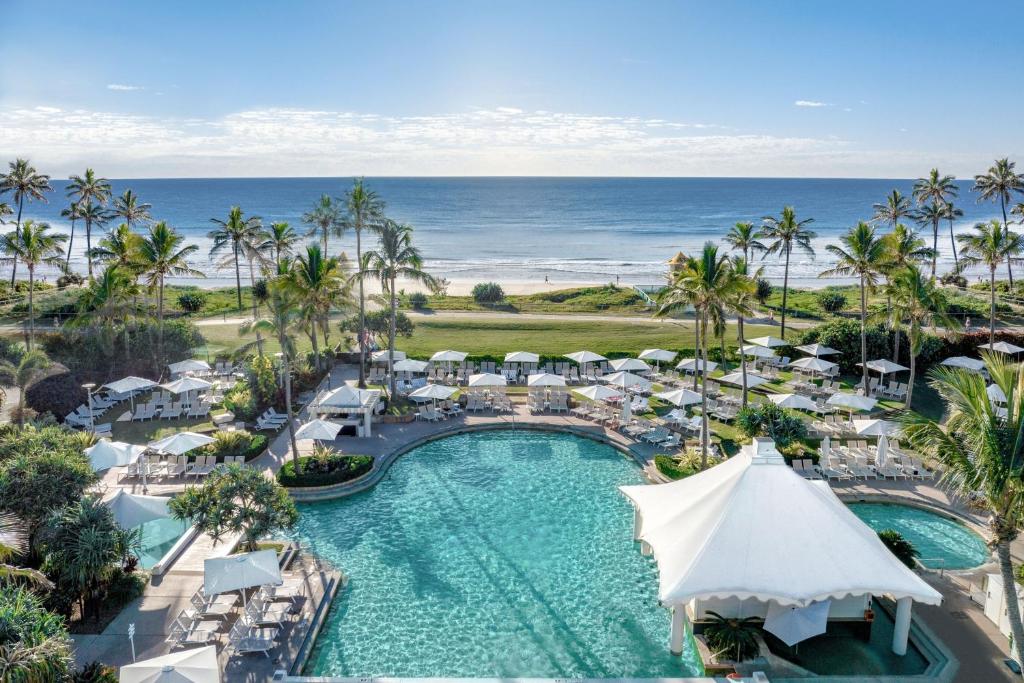 an aerial view of a resort with a pool and the ocean at Sheraton Grand Mirage Resort Gold Coast in Gold Coast
