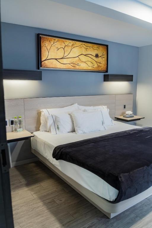 Postel nebo postele na pokoji v ubytování HOTEL LEMON GREEN -Zona Expo Frente al Centro de Convenciones