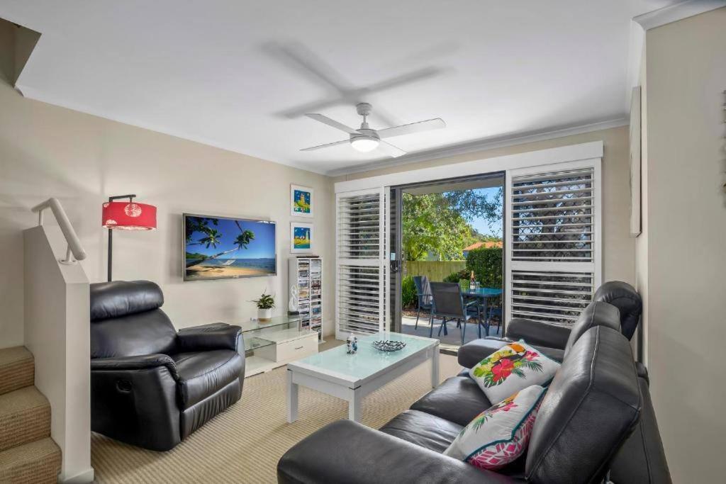 a living room with a couch and chairs and a table at Noosa River Walk - Unit 107 in Noosaville