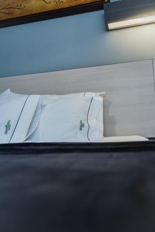 Postel nebo postele na pokoji v ubytování HOTEL LEMON GREEN -Zona Expo Frente al Centro de Convenciones