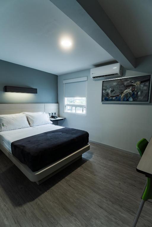 Postel nebo postele na pokoji v ubytování HOTEL LEMON GREEN -Zona Expo Frente al Centro de Convenciones