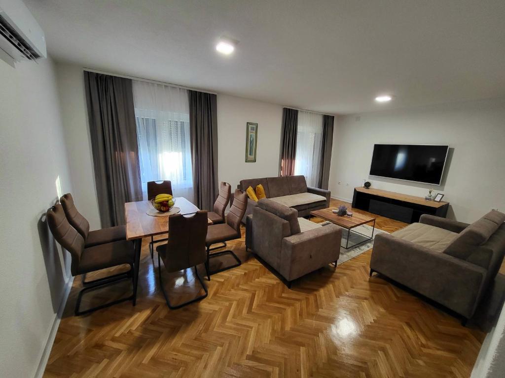 a living room with a couch and a table at Apartments & Spa - Insula Vita in Bihać