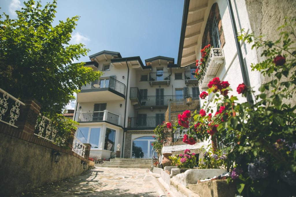 a building with balconies and flowers on a street at B&B il Cappellaio di Erika in Brovello-Carpugnino