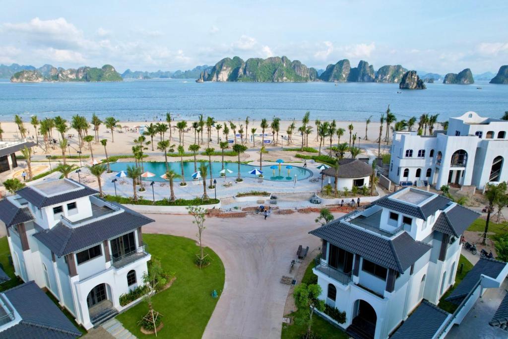 an aerial view of a resort with a beach and buildings at Lavender Sonasea Vân Đồn, Quảng Ninh in Quang Ninh