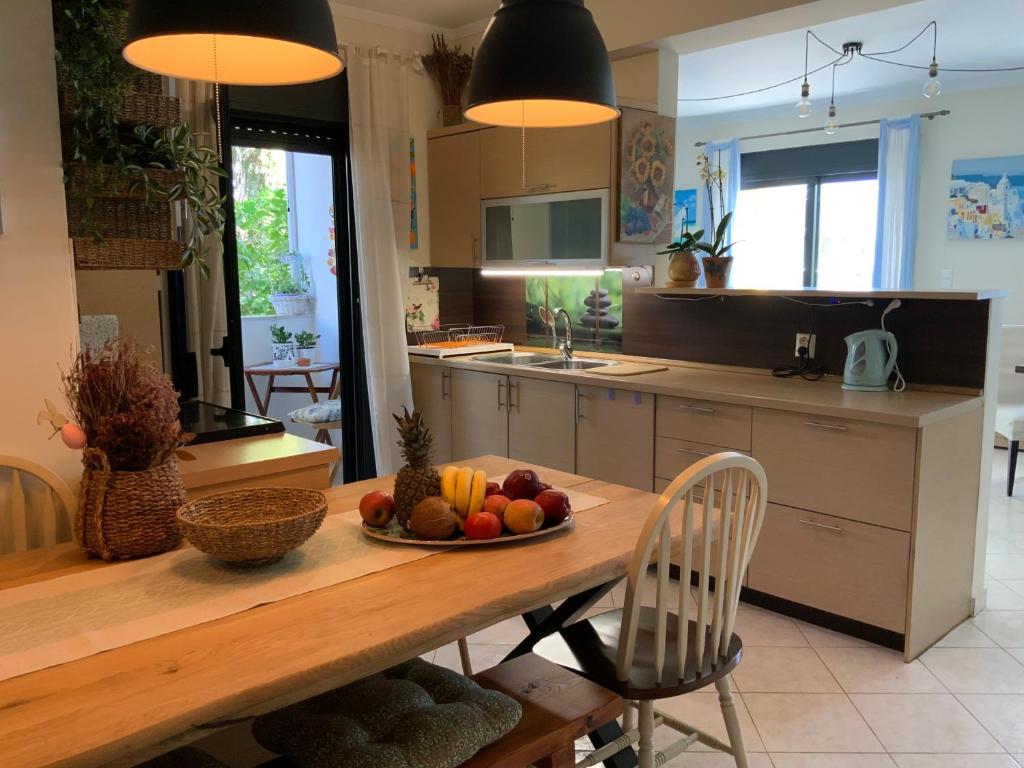 a kitchen with a table with a bowl of fruit on it at Γαλήνη in Salamina