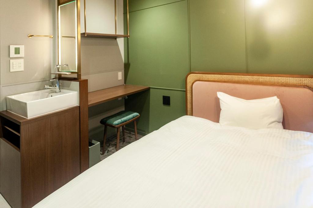 Postel nebo postele na pokoji v ubytování Mito Sannomaru Hotel