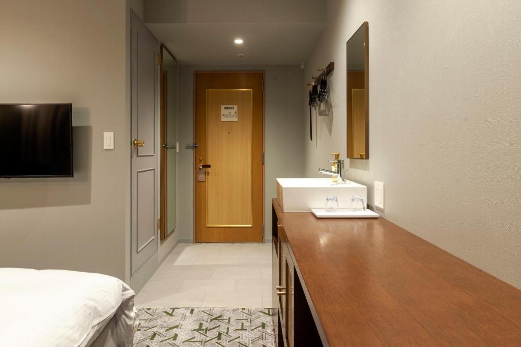 Postel nebo postele na pokoji v ubytování Mito Sannomaru Hotel