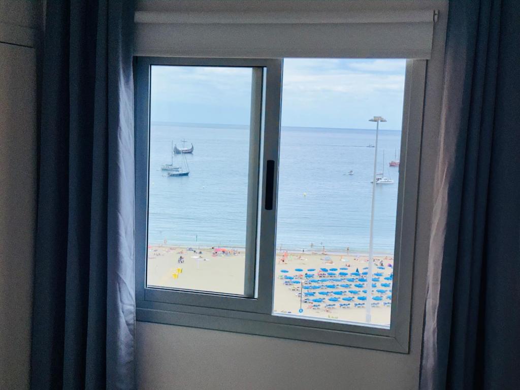 a window in a room with a view of a beach at Torres del Sol Playa de Las Vistas FREE WIFI in Playa de las Americas