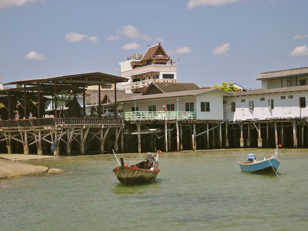 two boats in the water in front of a pier at Fulay Hotel in Hua Hin