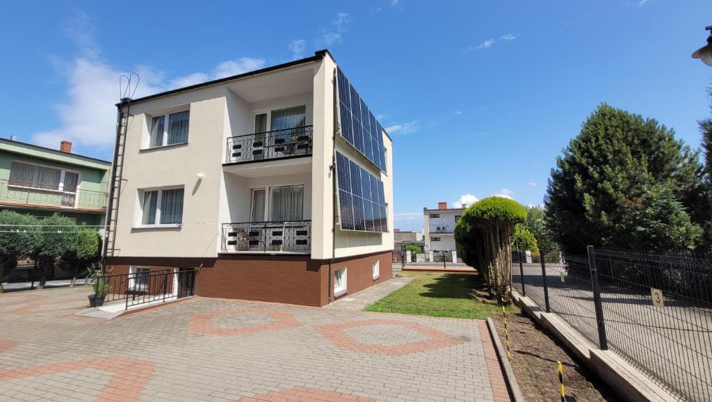 a white building with windows and a fence at Kojo 2 in Władysławowo