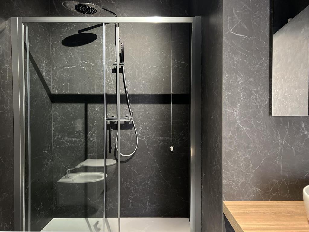 a shower with a glass door in a bathroom at Glass House - Smart Rooms & Parking in Lecce