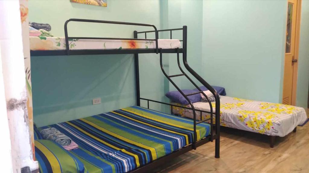 a couple of bunk beds in a room at Azulea Lodging House Oslob in Oslob