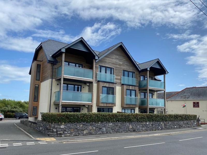 a large apartment building on the side of the street at 1 Y Bae - Top Floor Apartment in Trearddur