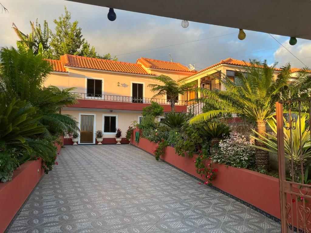 a courtyard of a house with plants and trees at Casa da Isilda ,three bedrooms in Estreito da Calheta