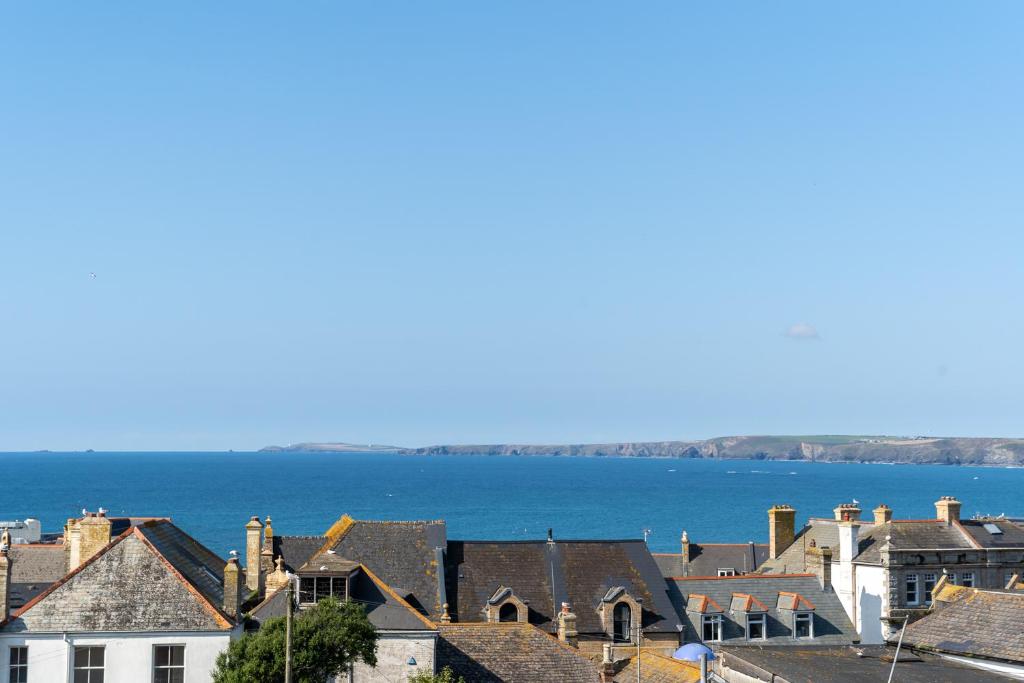 a view of a town with the ocean in the background at 4 Bedroom House in Newquay