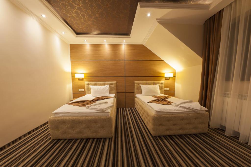 Postel nebo postele na pokoji v ubytování Allegria Hotel