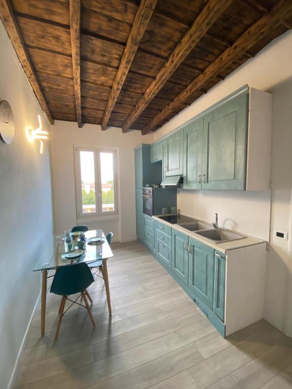 uma cozinha com armários azuis e uma mesa em CV Martesana Gessate em Gessate