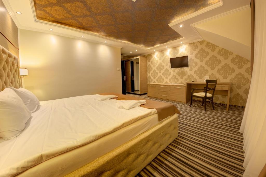 Postel nebo postele na pokoji v ubytování Allegria Hotel