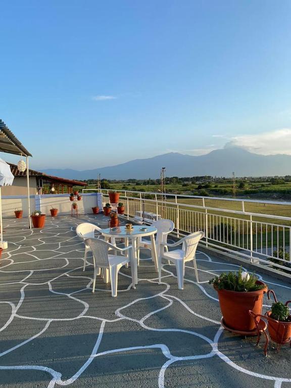 a patio with a table and chairs on a deck at Blue Sky Apartment Paralia in Paralia Katerinis