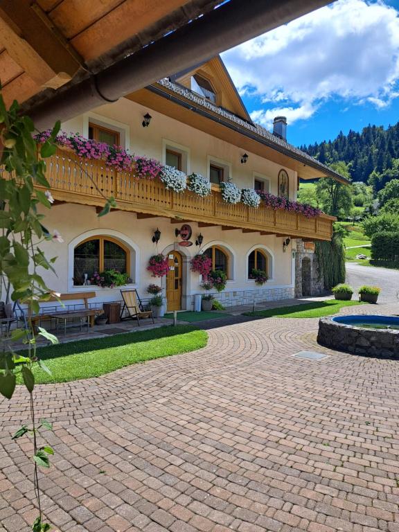 a large house with a balcony and a patio at Guest House Kveder in Škofja Loka