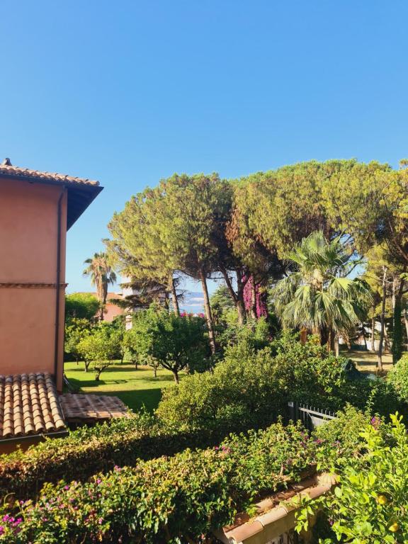 a view of a garden with trees and bushes at Mosè House in Formia