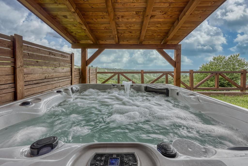 a jacuzzi tub on a porch with a wooden roof at Holiday Home Primus in Jastrebarsko