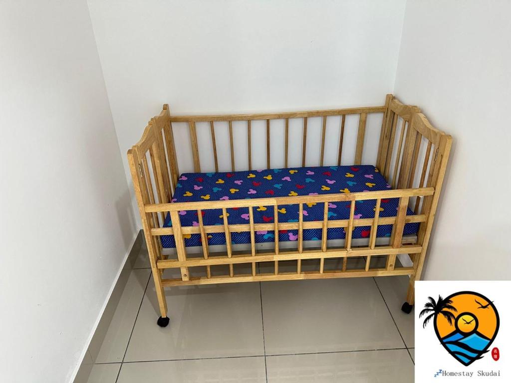 a wooden crib in a corner of a room at ZZZ HOMESTAY SKUDAI in Skudai