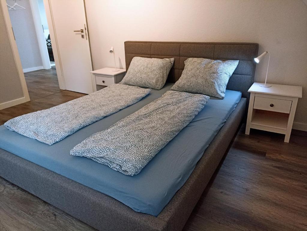 a bed with two pillows on top of it at Ferienwohnung Adriane in Nordhorn