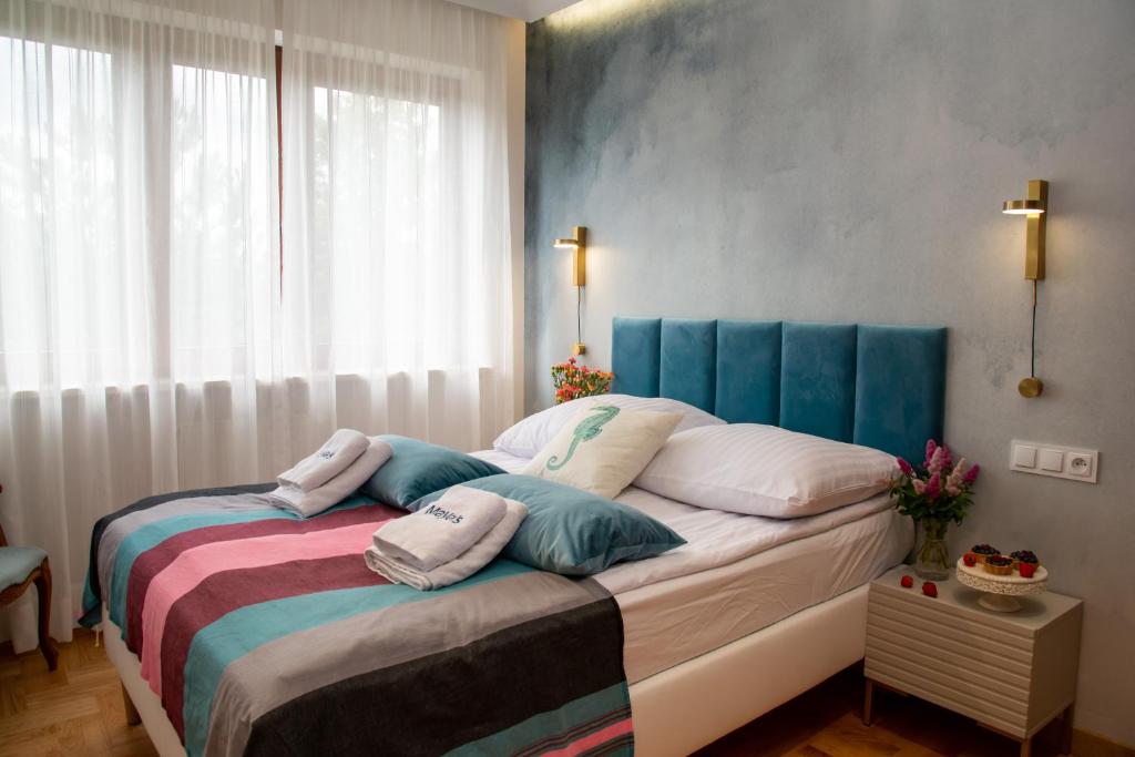 a bedroom with a bed with pillows on it at Maya's Flats & Resorts 102 - PREMIUM 3 rooms apartment near the sea in Gdańsk