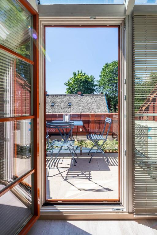 a sliding glass door with a view of a patio at Nauji apartamentai! Pamario 14 in Nida
