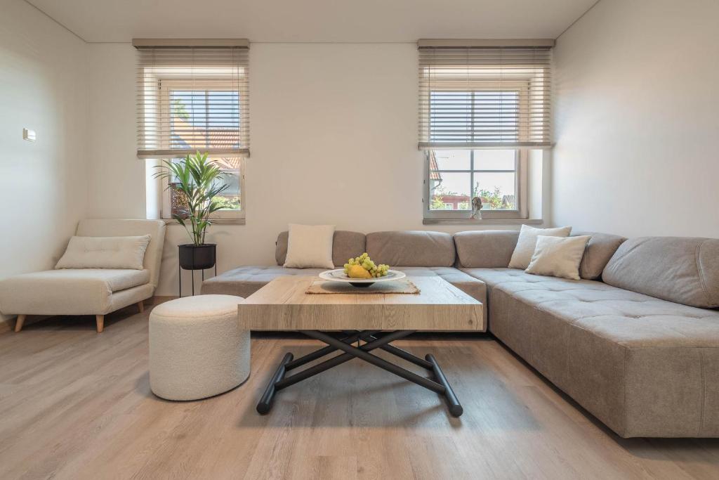 a living room with a couch and a table at Nauji apartamentai! Pamario 14 in Nida